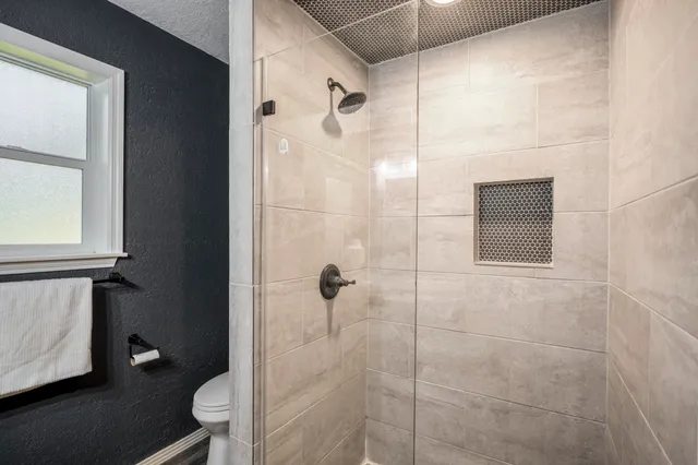 a bathroom with a shower toilet and sink