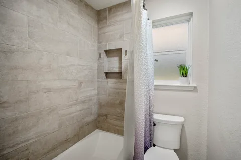 a bathroom with a toilet and shower