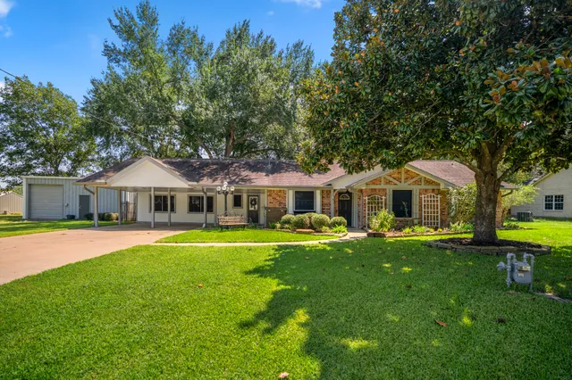 a front view of a house with a garden