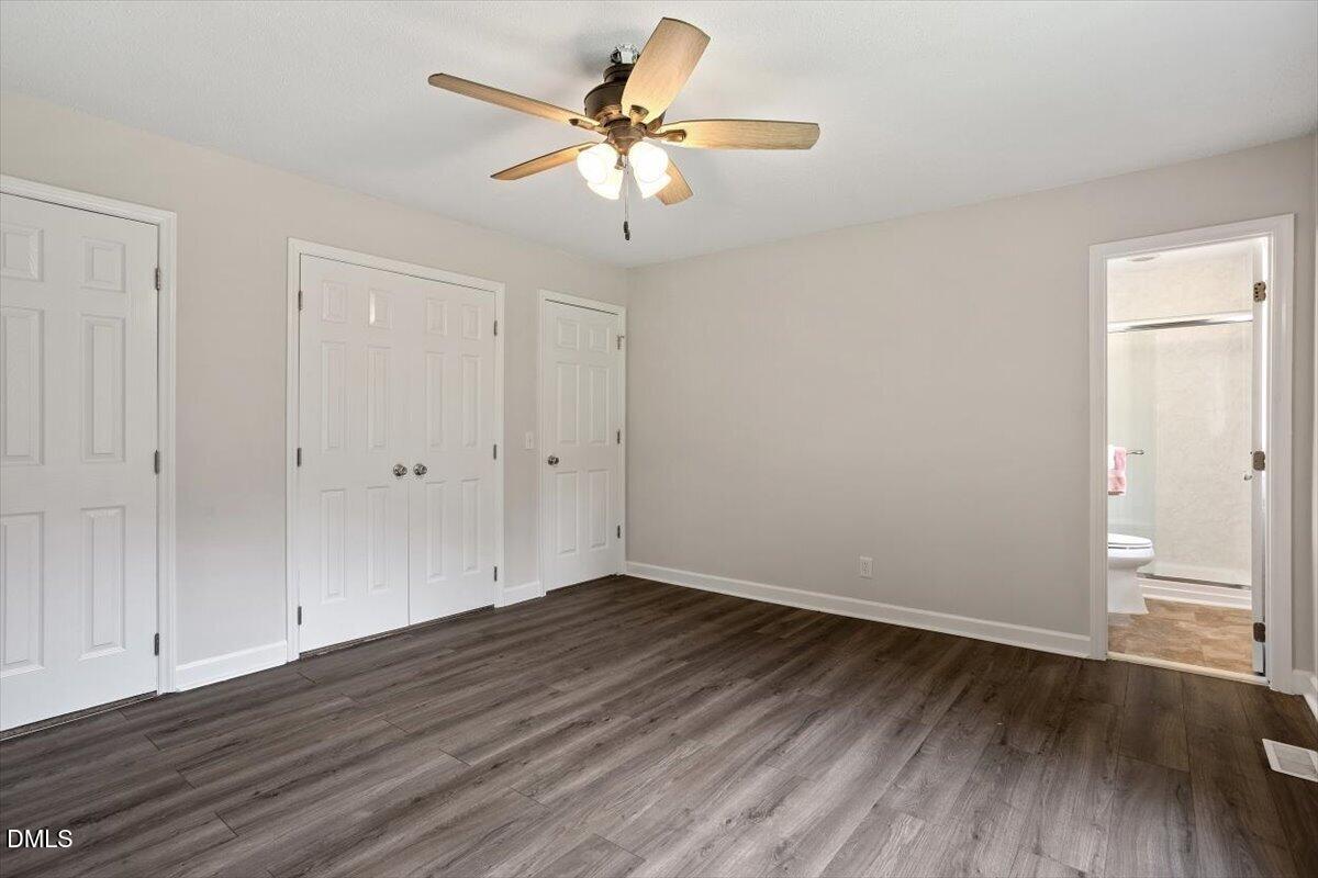 805 Rand Road Garner, NC 27529 - Photo 31 of 38 a view of a room with wooden floor and a ceiling fan
