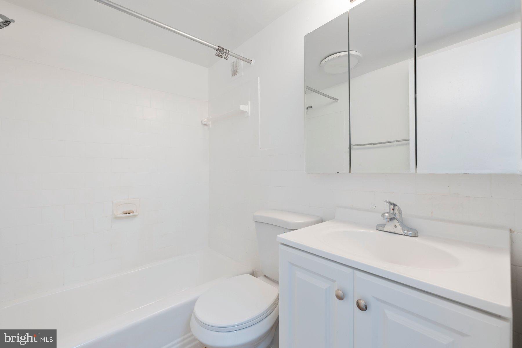 1824 Metzerott Road, Unit 203 Hyattsville, MD 20783 - Photo 13 of 19 a bathroom with a sink a toilet and shower