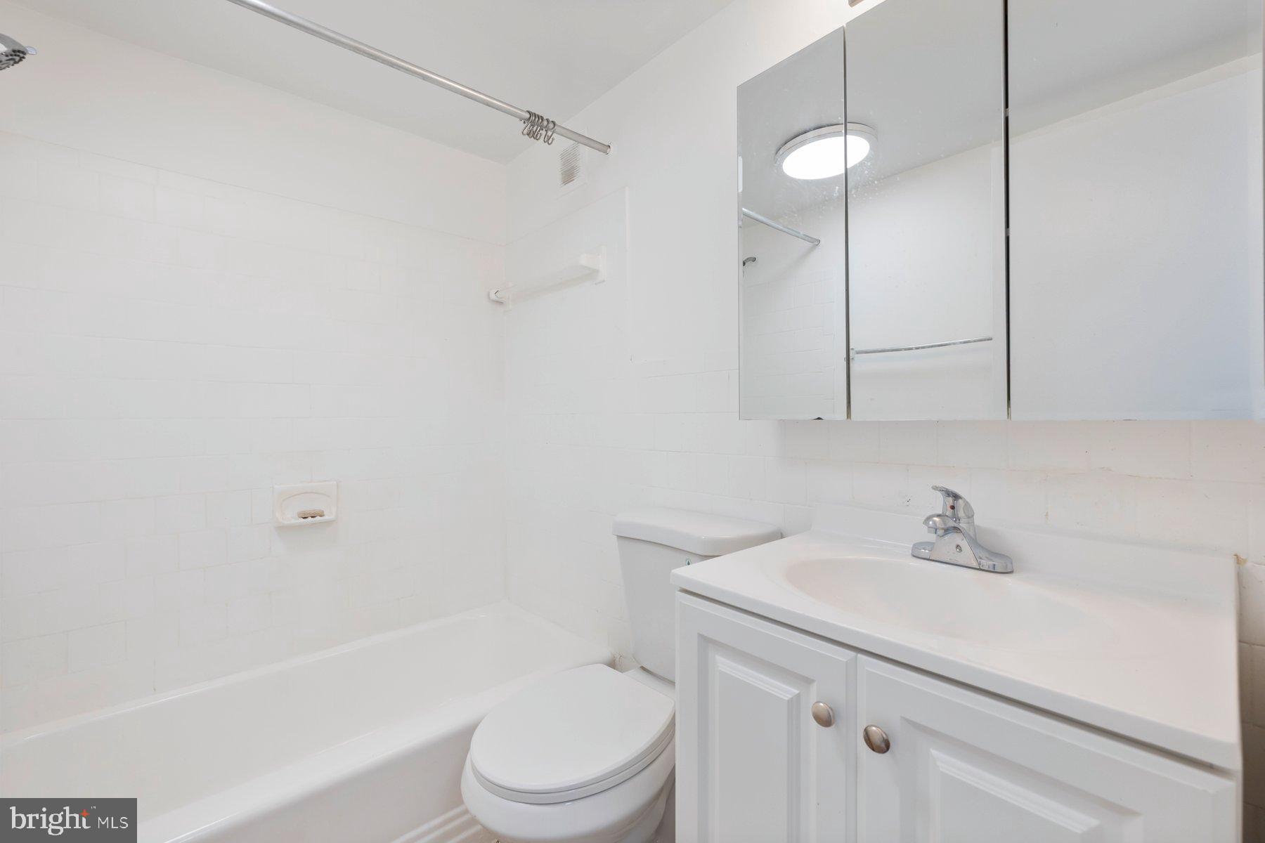 1824 Metzerott Road, Unit 203 Hyattsville, MD 20783 - Photo 14 of 19 a bathroom with a sink a toilet and shower