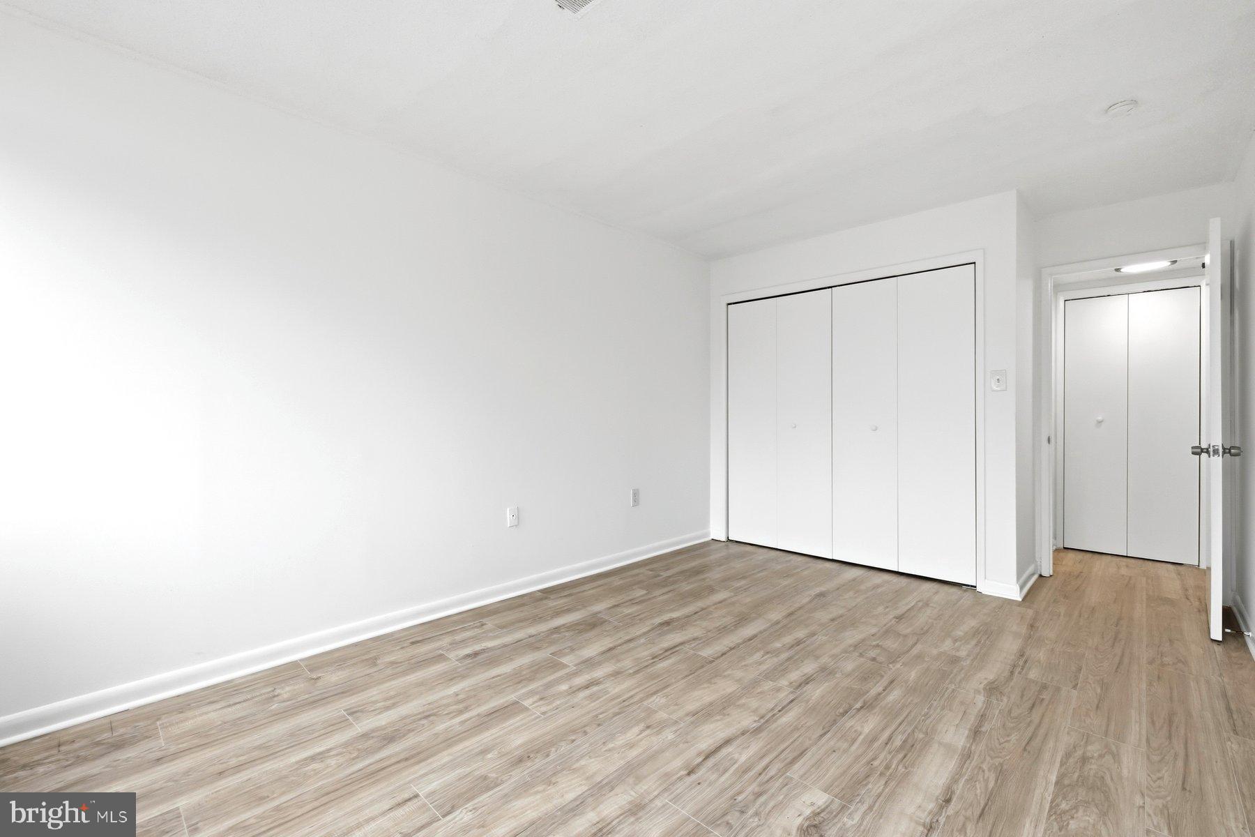 1824 Metzerott Road, Unit 203 Hyattsville, MD 20783 - Photo 16 of 19 a view of an empty room with wooden floor