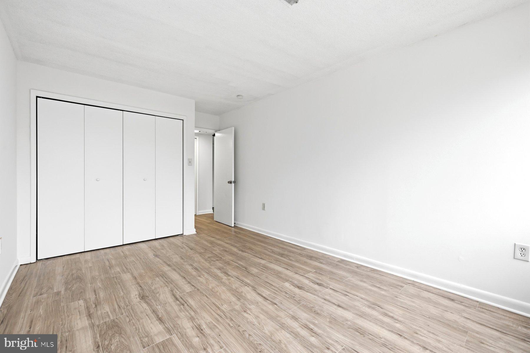 1824 Metzerott Road, Unit 203 Hyattsville, MD 20783 - Photo 17 of 19 a view of an empty room with wooden floor