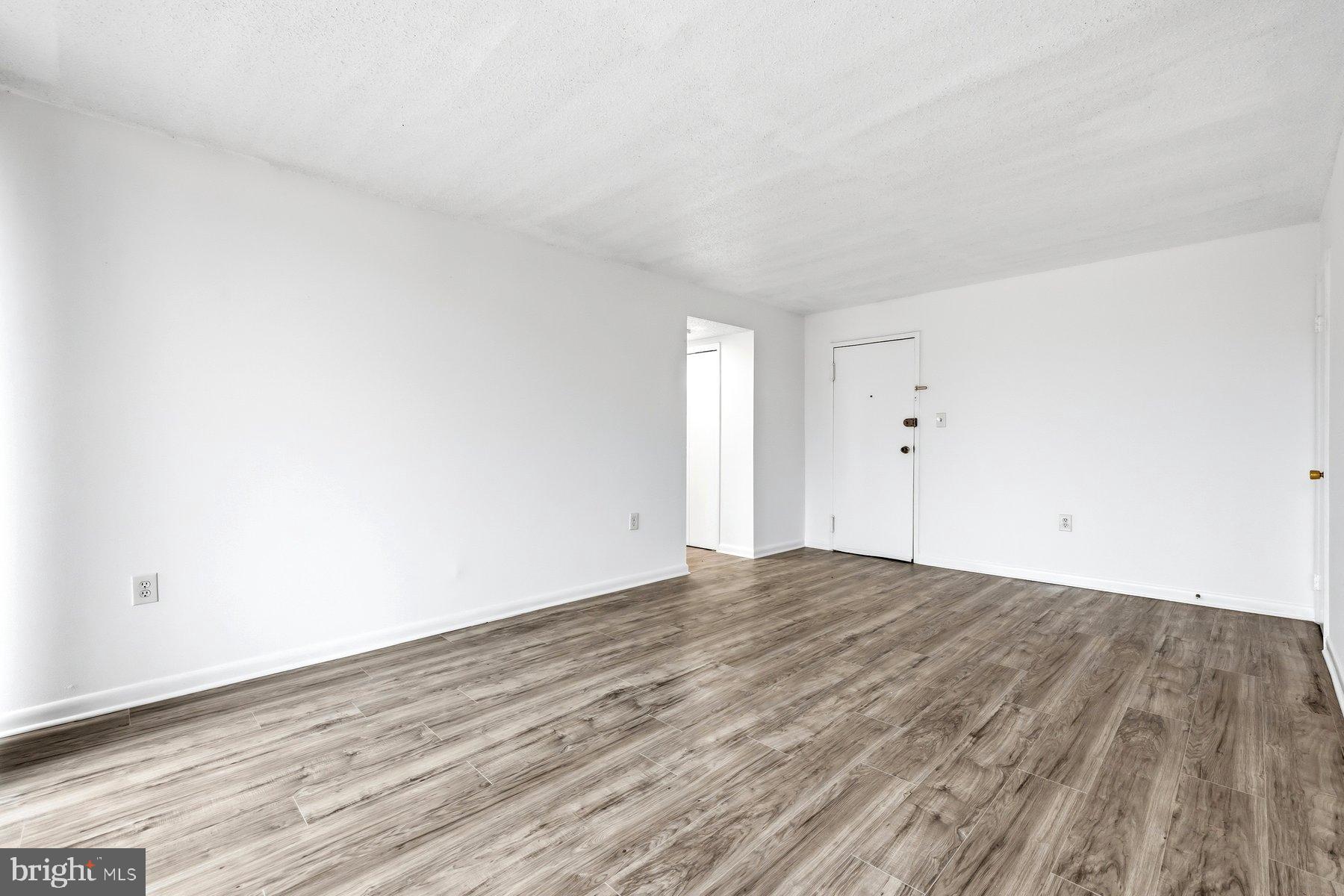 1824 Metzerott Road, Unit 203 Hyattsville, MD 20783 - Photo 6 of 19 a view of an empty room and wooden floor