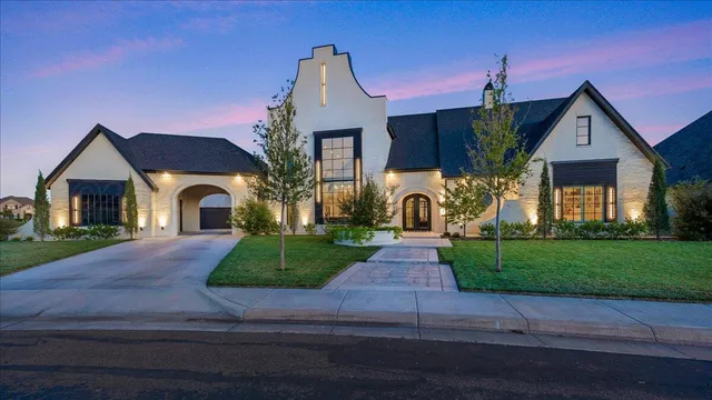 a kitchen with stainless steel appliances granite countertop a stove and a refrigerator with white cabinets