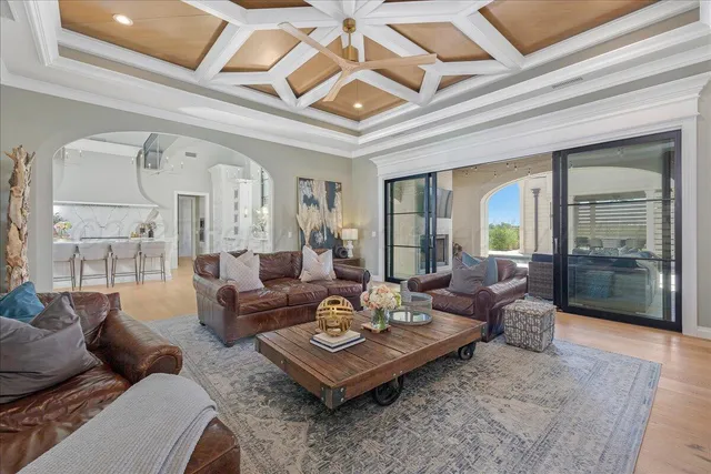 a view of a white house with a big yard and large trees