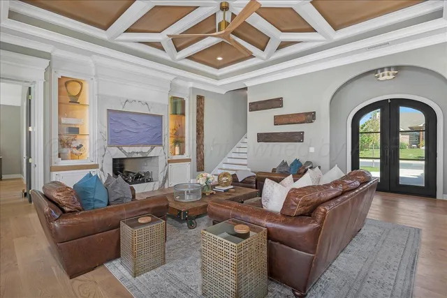 a living room with furniture and a ceiling fan