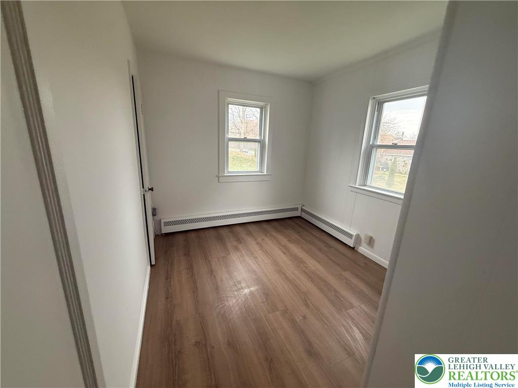 5029 Grammes Road Orefield, PA 18069 - Photo 11 of 14 a view of an empty room with wooden floor and a window