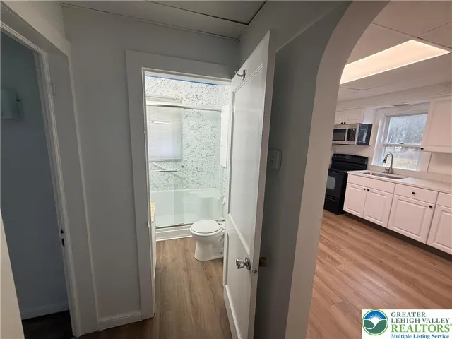 a bathroom with a granite countertop sink a toilet and a vanity