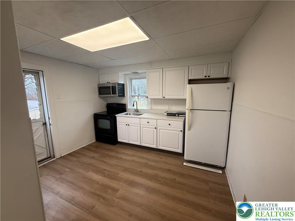 5029 Grammes Road Orefield, PA 18069 - Photo 6 of 14 a kitchen with a refrigerator a microwave and sink