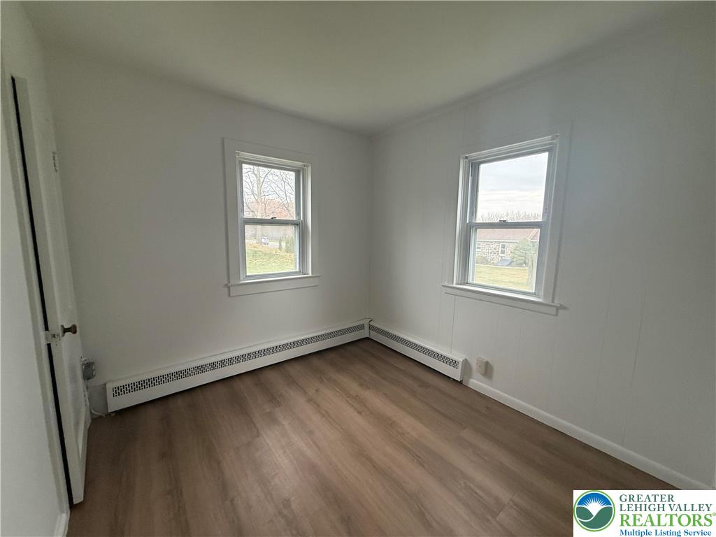 5029 Grammes Road Orefield, PA 18069 - Photo 10 of 14 an empty room with wooden floor and windows
