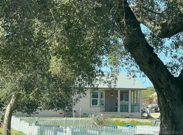 front view of a house with a tree