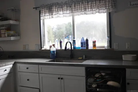 a kitchen with a sink and large window