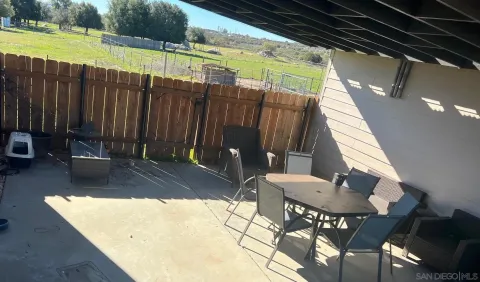 a view of a patio with a table and chairs