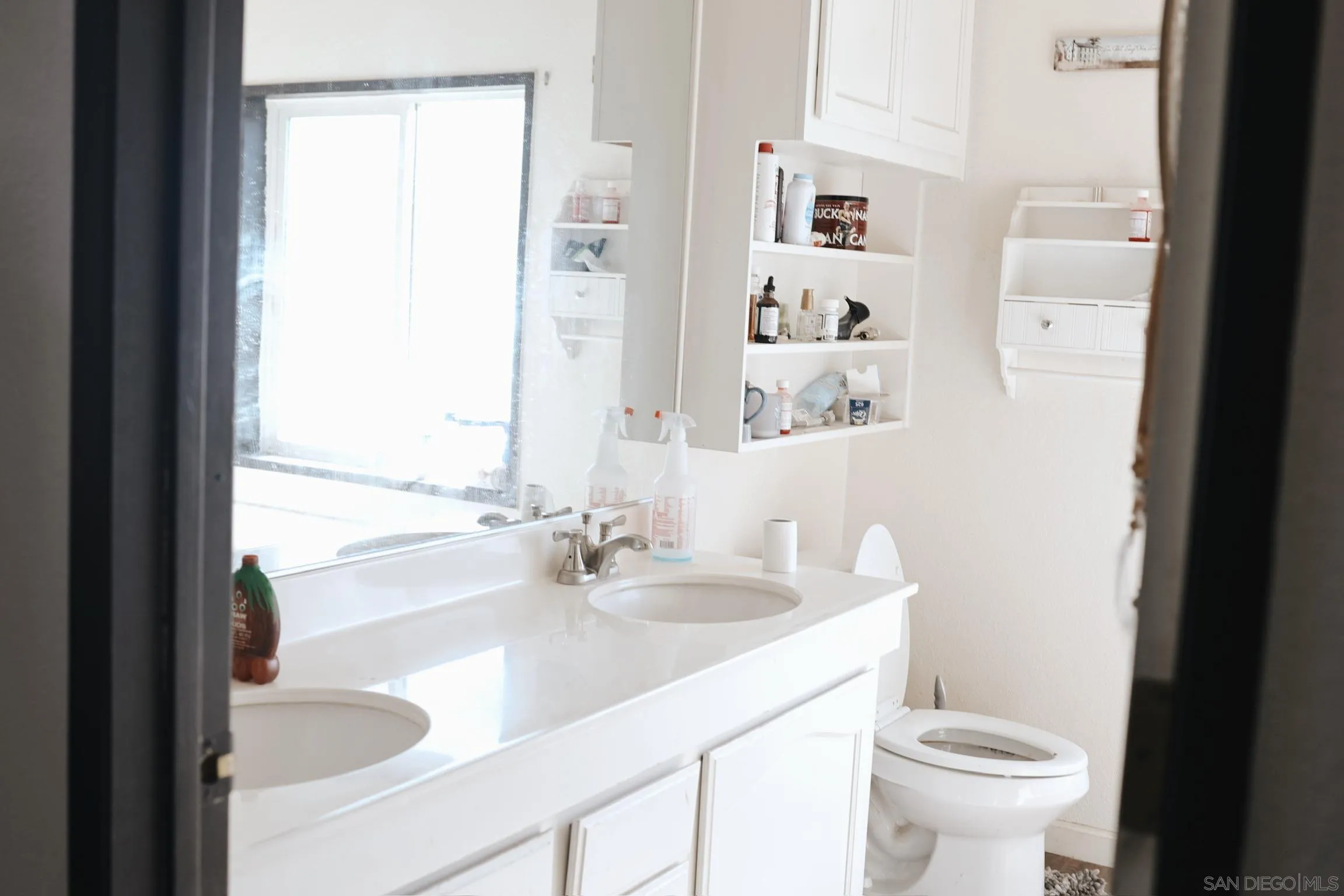 1122 Tierra Del Sol Road Boulevard, CA 91905 - Photo 5 of 26 a bathroom with a sink a toilet and a mirror