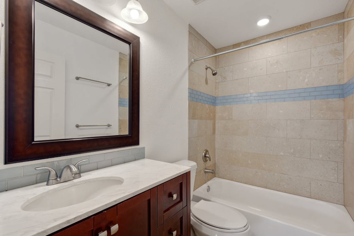 1311 East 52nd Street, Unit 3 Austin, TX 78723 - Photo 17 of 20 a bathroom with a sink a toilet and shower