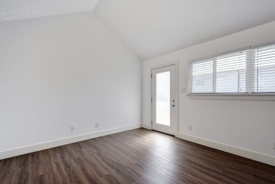 1311 East 52nd Street, Unit 3 Austin, TX 78723 - Photo 3 of 20 an empty room with wooden floor and windows