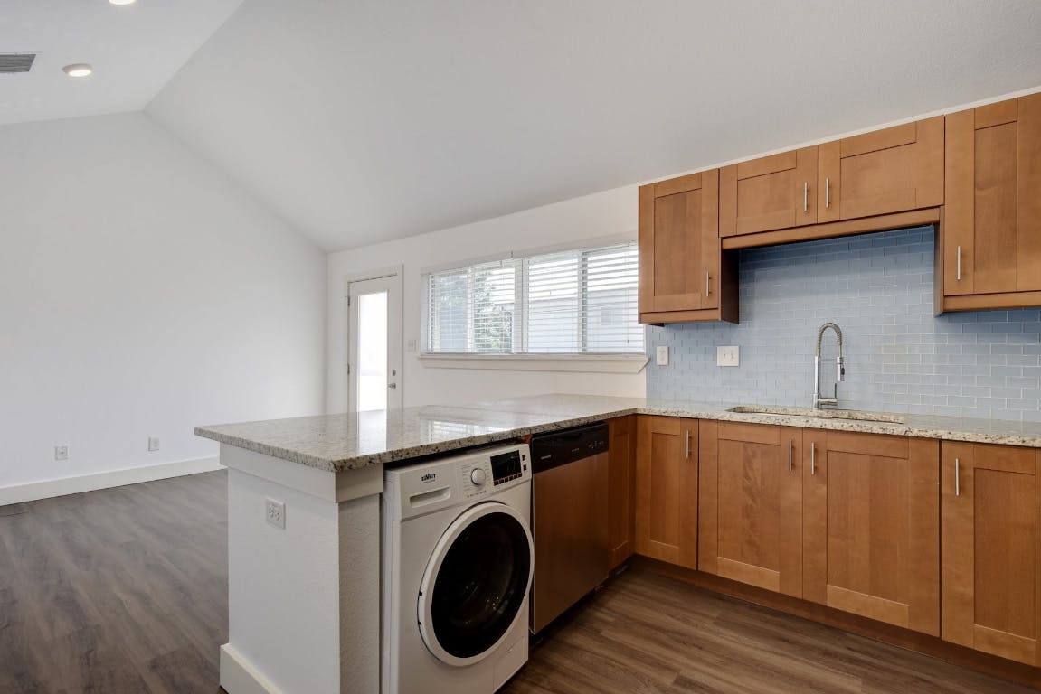 1311 East 52nd Street, Unit 3 Austin, TX 78723 - Photo 7 of 20 a kitchen with a sink a washer and dryer