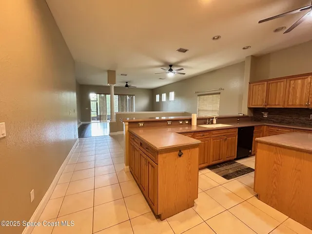 a kitchen with stainless steel appliances granite countertop a sink and cabinets