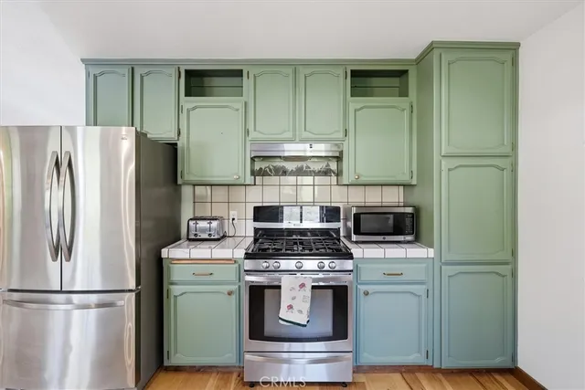 a kitchen with stainless steel appliances granite countertop a sink and cabinets