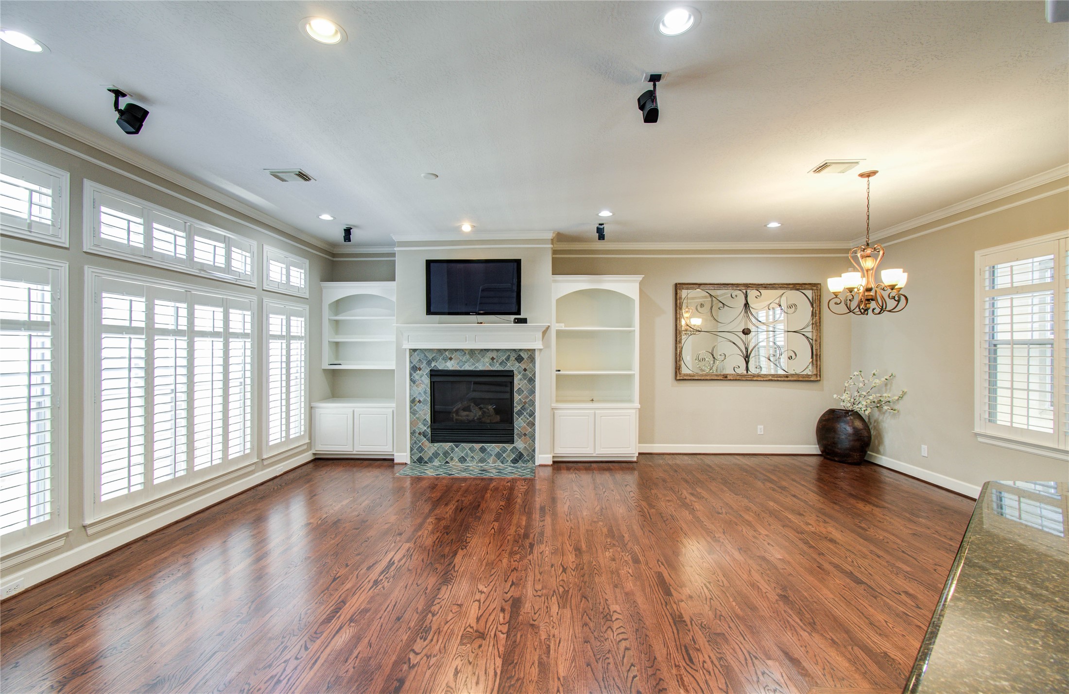 4613 Floyd Street Houston, TX 77007 - Photo 13 of 37 an empty room with windows fireplace and wooden floor