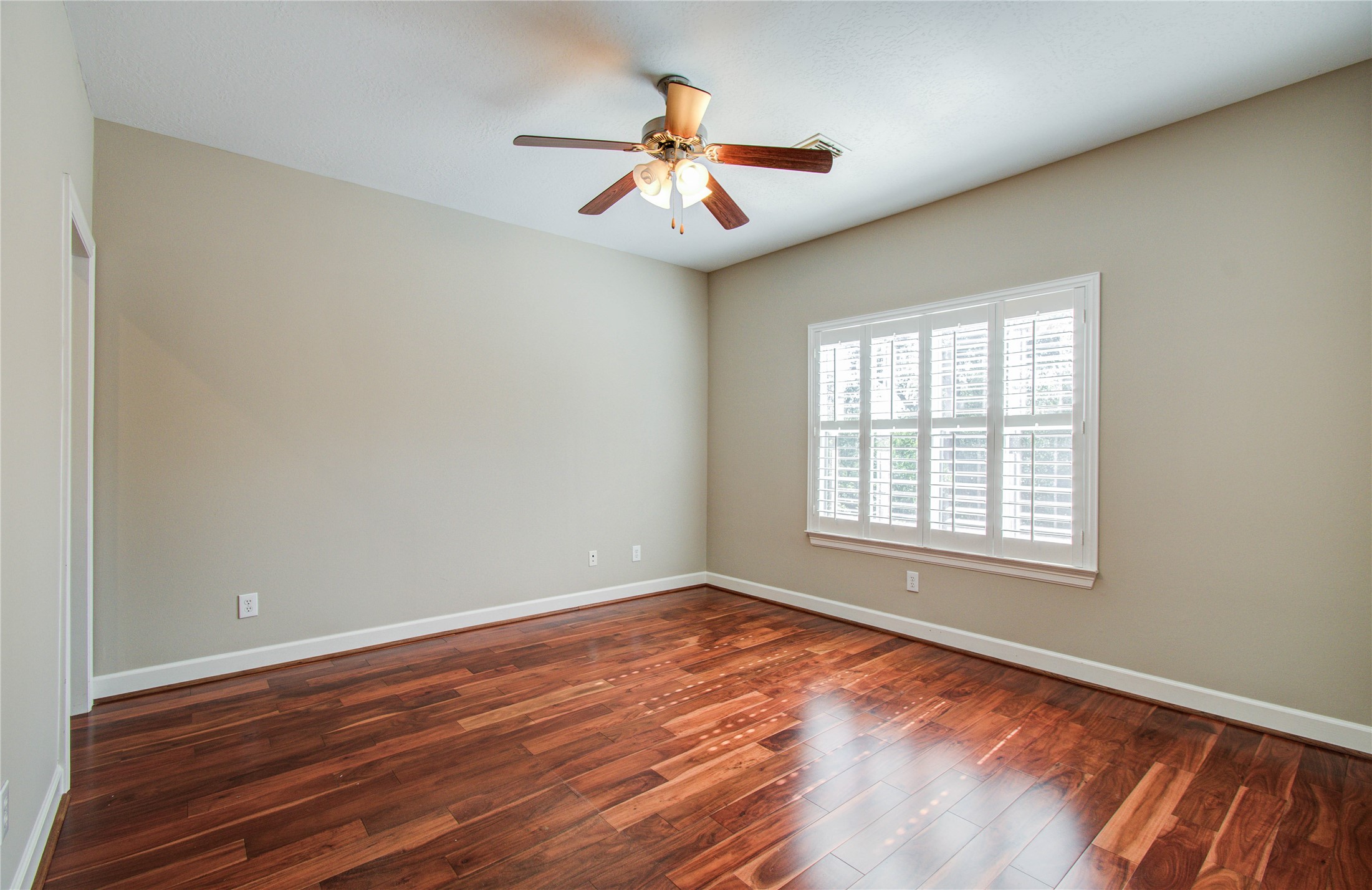 4613 Floyd Street Houston, TX 77007 - Photo 21 of 37 a view of an empty room with wooden floor and a window