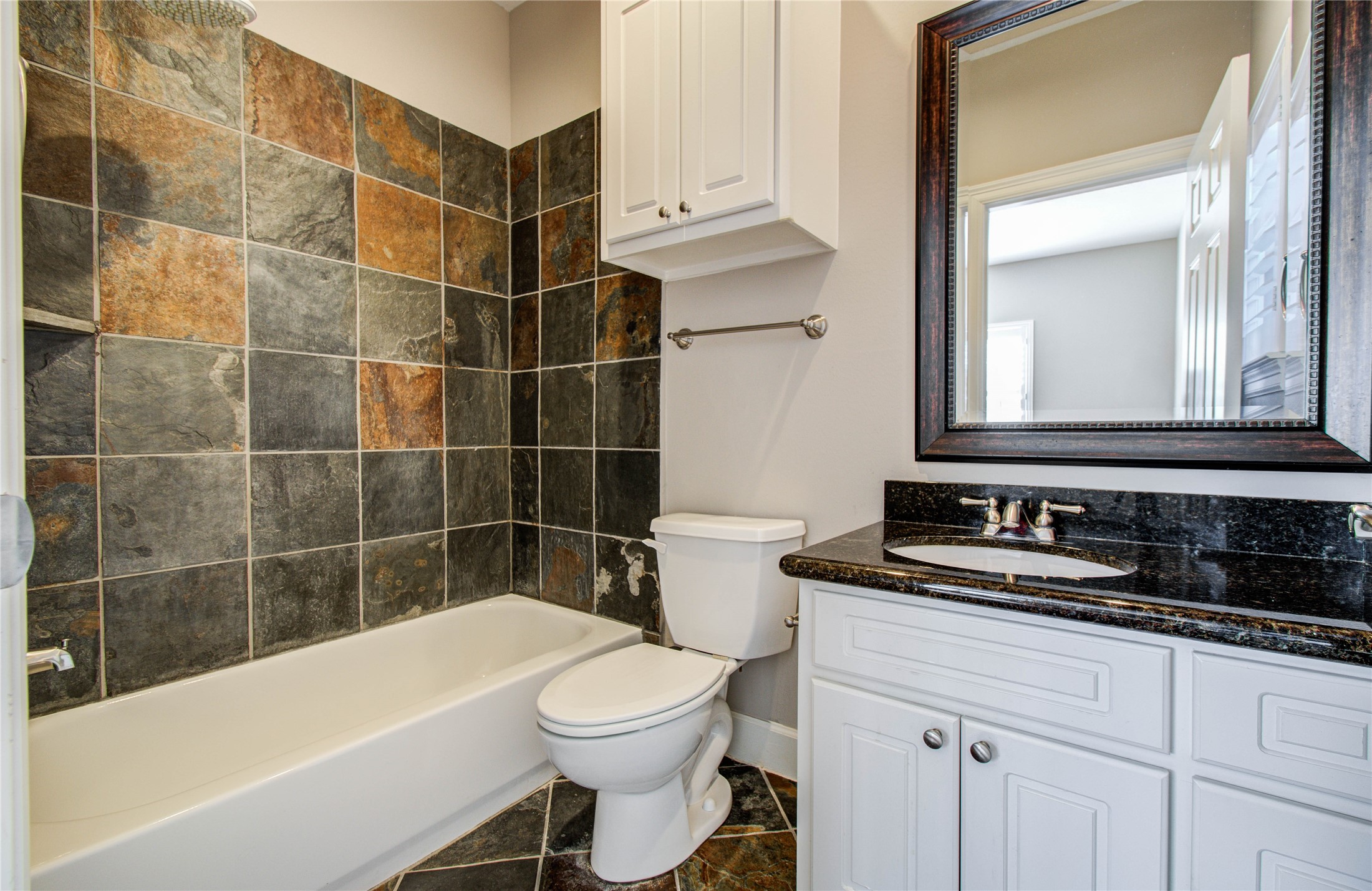 4613 Floyd Street Houston, TX 77007 - Photo 23 of 37 a bathroom with a sink a toilet a mirror a bathtub and shower
