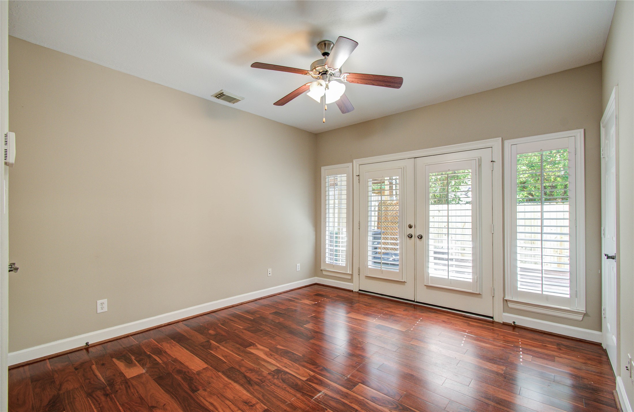 4613 Floyd Street Houston, TX 77007 - Photo 30 of 37 an empty room with wooden floor fan and windows
