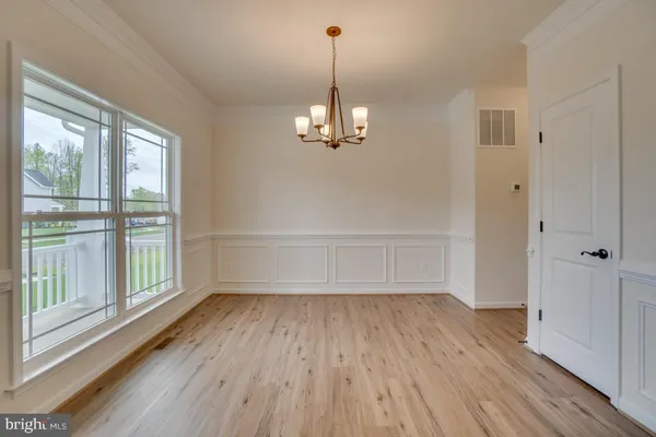 a view of a room with wooden floor staircase and a window