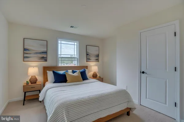 a bedroom with a bed and a night stand