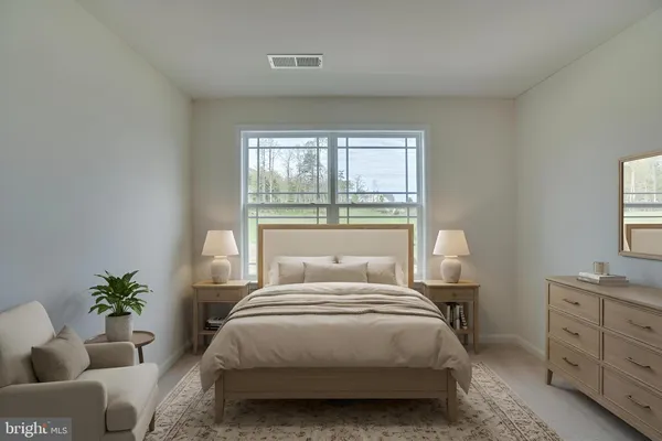 a bedroom with a bed and a potted plant