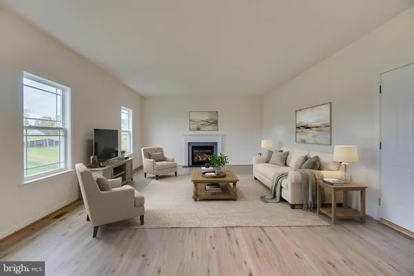 a living room with fireplace furniture flat screen tv and windows