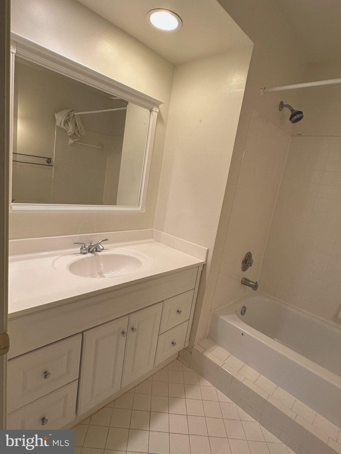 7808 Spinnaker Road, Unit 12 Laurel, MD 20707 - Photo 14 of 23 a bathroom with a sink vanity tub and shower