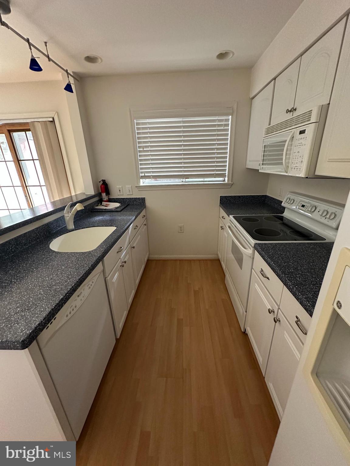 7808 Spinnaker Road, Unit 12 Laurel, MD 20707 - Photo 6 of 23 a kitchen with granite countertop a sink stove and cabinets