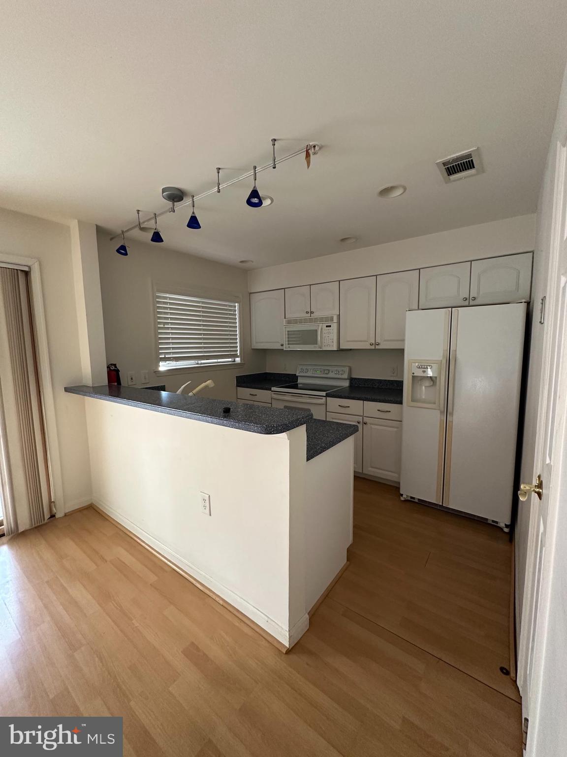 7808 Spinnaker Road, Unit 12 Laurel, MD 20707 - Photo 7 of 23 a kitchen with stainless steel appliances a refrigerator a sink and white cabinets
