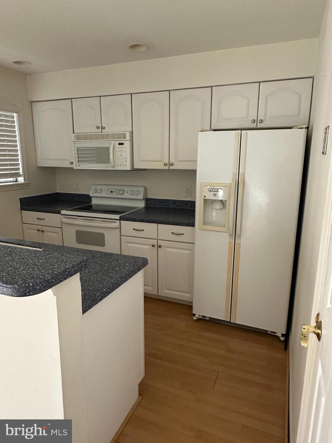 7808 Spinnaker Road, Unit 12 Laurel, MD 20707 - Photo 8 of 23 a kitchen with granite countertop a refrigerator sink stove and cabinets