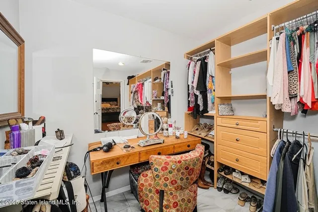a room with a baby crib furniture and a window
