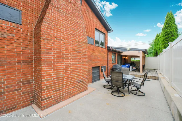 a view of a patio with table and chairs and potted plants