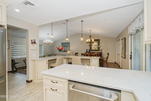 a kitchen with kitchen island a sink stainless steel appliances and cabinets