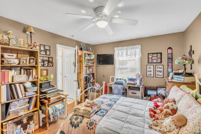 a bedroom with furniture and a book shelf