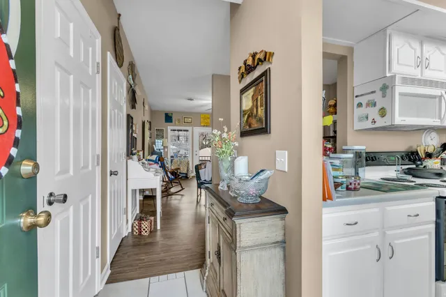 a kitchen that has a lot of cabinets a sink and a refrigerator