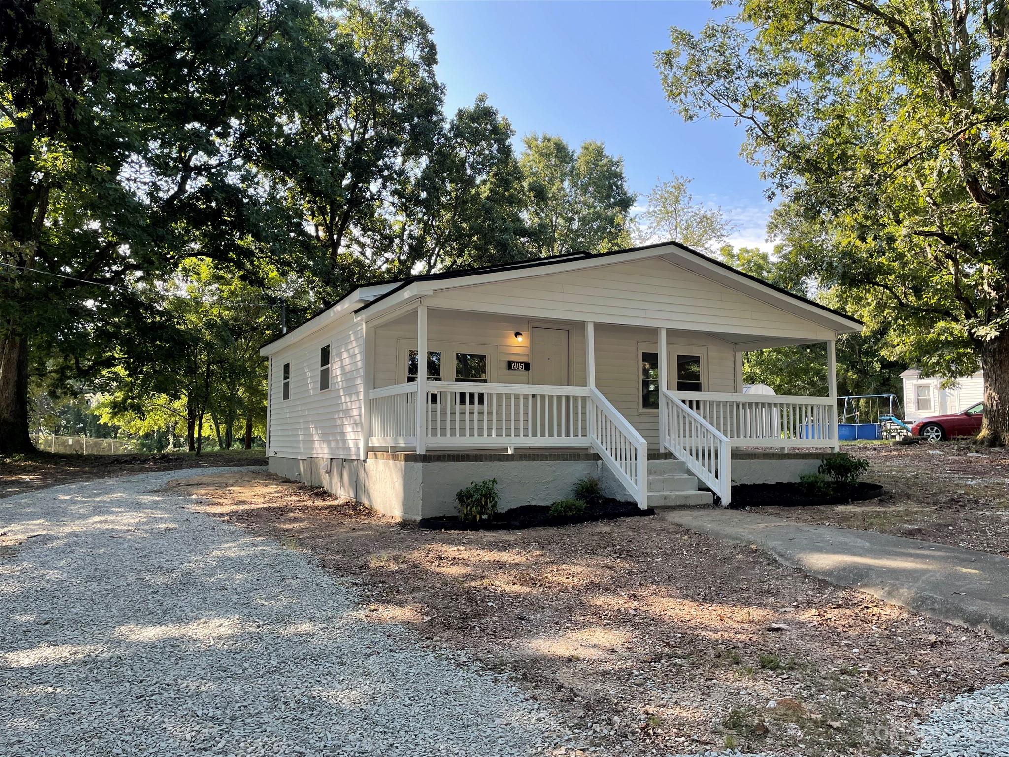 205 Jerome Street Wingate, NC 28174 - Photo 1 of 7 a view of a house with a yard