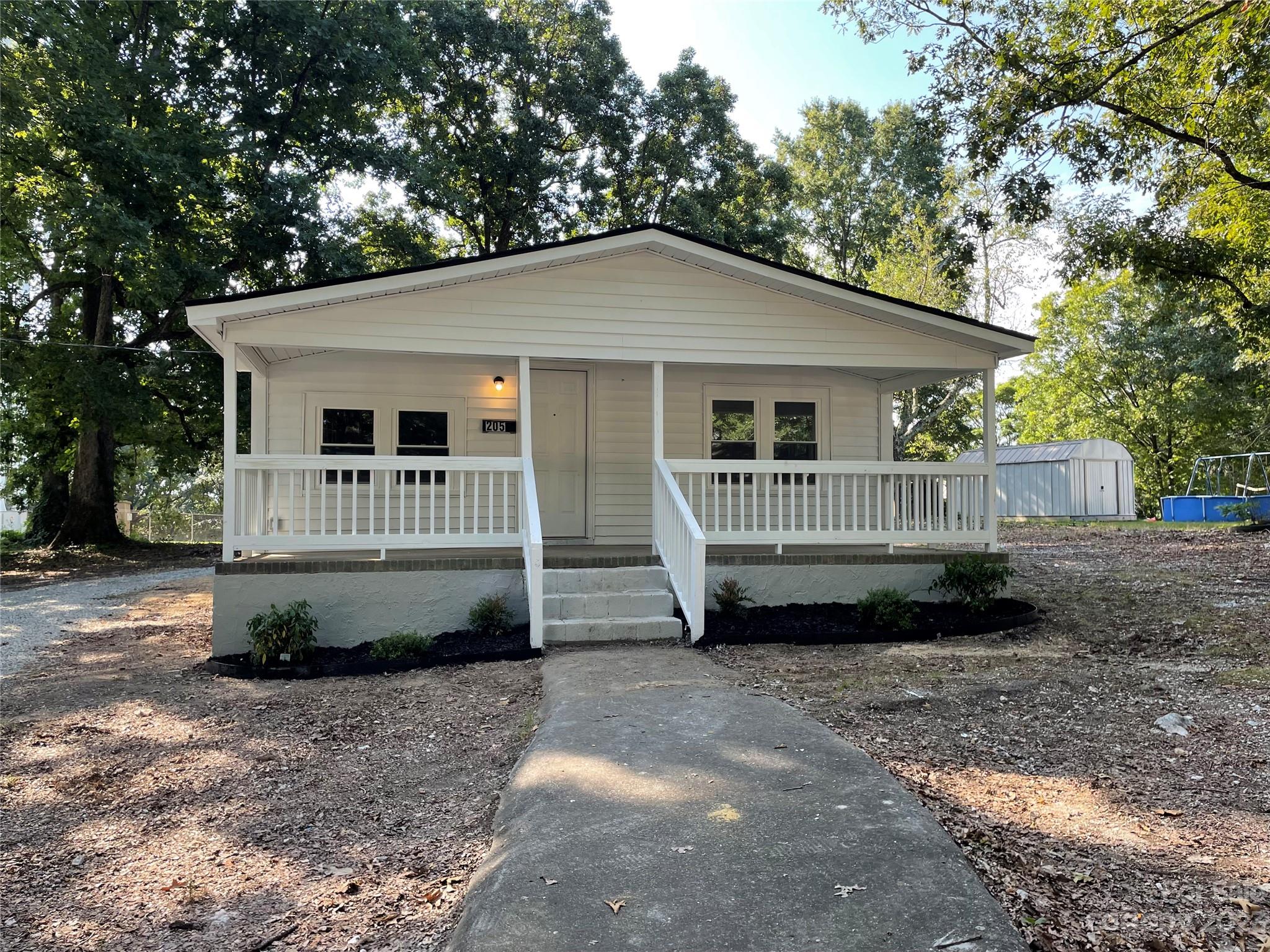 205 Jerome Street Wingate, NC 28174 - Photo 2 of 7 a front view of a house with a yard