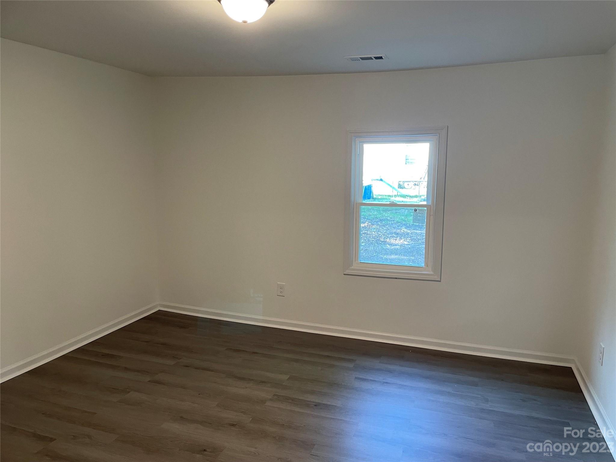 205 Jerome Street Wingate, NC 28174 - Photo 7 of 7 a view of a small space with wooden floor and windows