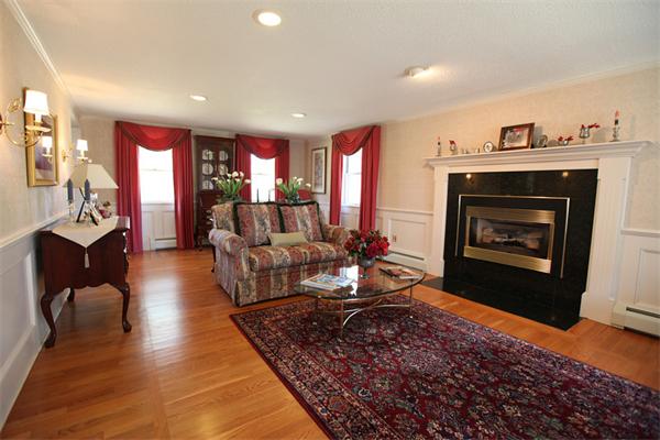 72 Sarah Sherman Road Rochester, MA 02770 - Photo 2 of 17 a living room with furniture and a fireplace