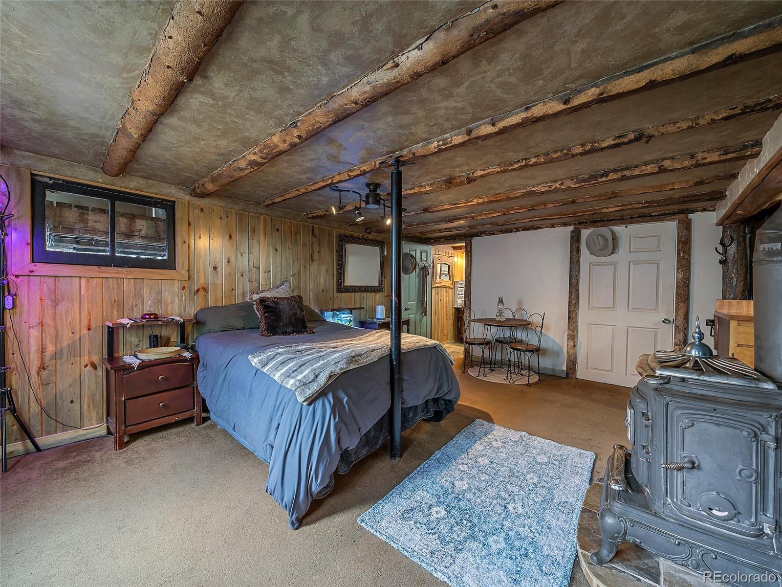 24293 Running Deer Road Conifer, CO 80433 - Photo 18 of 33 a bedroom with bed or furniture and a couch