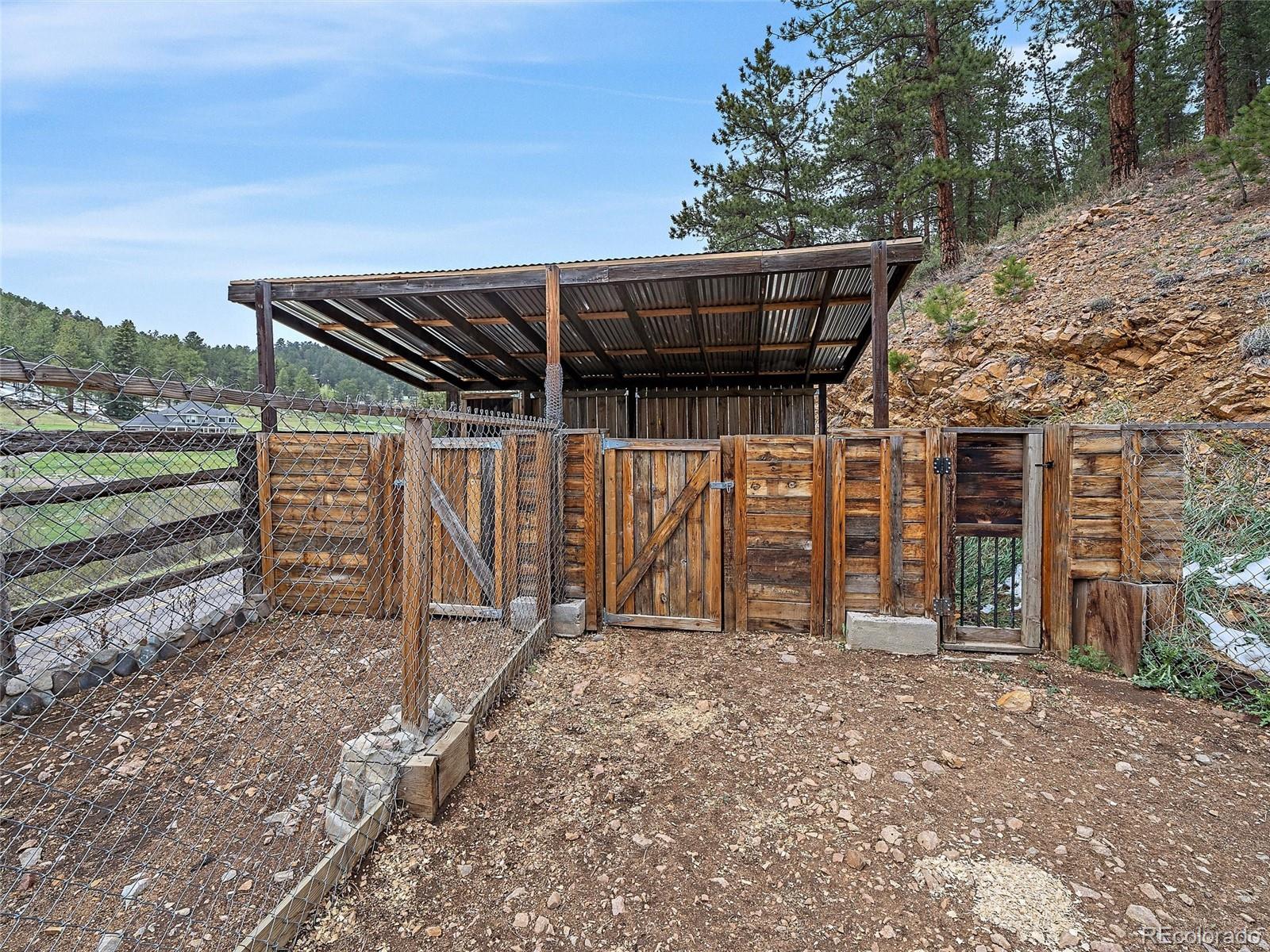 24293 Running Deer Road Conifer, CO 80433 - Photo 30 of 33 a view of a house with a backyard
