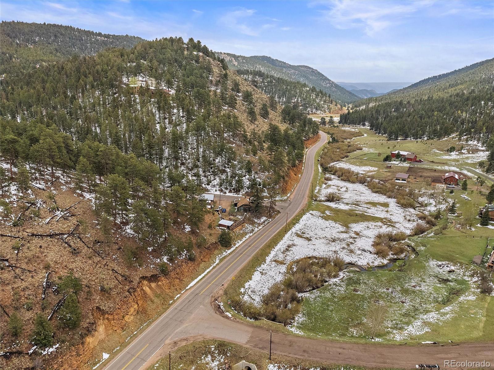 24293 Running Deer Road Conifer, CO 80433 - Photo 33 of 33 a view of a mountain from a yard