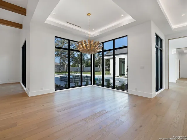a view of a room with lots of windows and a chandelier